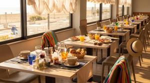 a row of tables in a restaurant with food at Igea Spiaggia Home Holiday in Bellaria-Igea Marina +39 photos