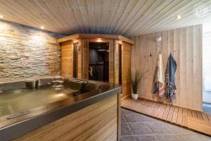a kitchen with a sink and a wooden wall at Gites le moulin - lanchette in La Compôte +30 photos