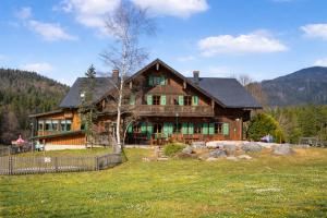 a large wooden house in the middle of a field at Blaa Alm in Altaussee