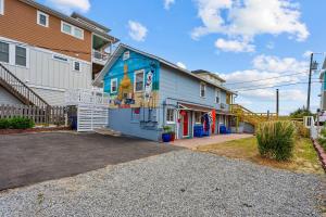 a house with a blue building in the driveway at Vitamin Sea Suites 4 in Carolina Beach