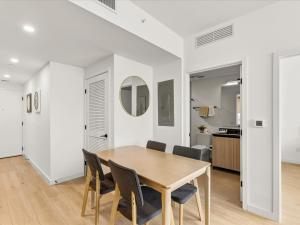 a dining room with a wooden table and chairs at Prime Downtown Miami Location with Rooftop Pool in Miami