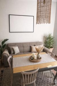 a living room with a table and a couch at Koralis in Petra