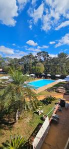 a view of a swimming pool from the balcony of a resort at Pousada Sant`Ana in Sabará