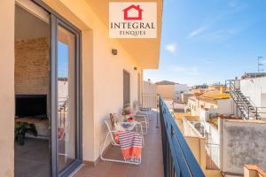 a balcony with a table and chairs on it at Les Voltes in Palamós