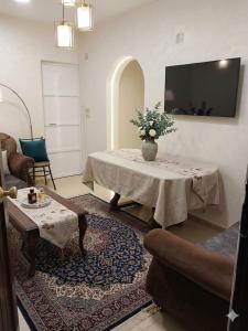 a living room with a table with a vase of flowers on it at شقة فاخرة موقع ممتاز in Aswan
