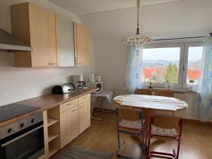 a kitchen with a table and chairs and a window at Lindenstraße in Aue-Bad Schlema