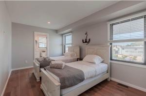 a bedroom with two beds and a window at The Anchorage Cape May in Cape May