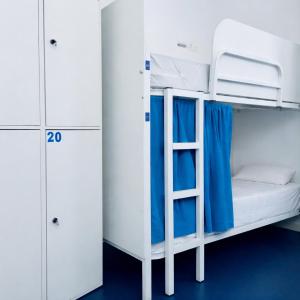 a bunk bed with a ladder in a room at Hostel Albergue Baionamar in Baiona