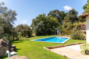 a swimming pool in the yard of a house at Casa do Cabeço in Maiorga