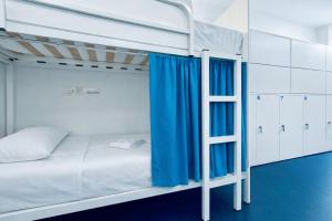 a bedroom with two bunk beds and a ladder at Hostel Albergue Baionamar in Baiona +17 photos
