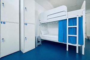 a room with two bunk beds and a ladder at Hostel Albergue Baionamar in Baiona