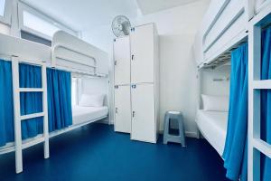 a dorm room with two bunk beds and a clock at Hostel Albergue Baionamar in Baiona