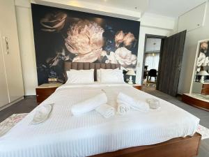 a bedroom with a large white bed with white pillows at Tropical Apartment Hanioti in Hanioti