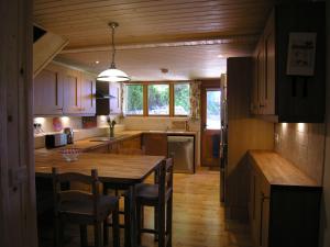 a kitchen with a large wooden table and chairs at Selworthy- Ukc4915 in Timberscombe