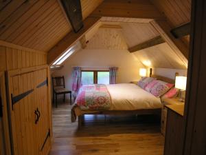 a bedroom with a bed in a wooden attic at Selworthy- Ukc4915 in Timberscombe +22 photos