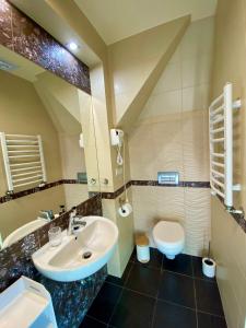 a bathroom with a sink and a toilet at Młyn Wielisław Agroturystyka i Restauracja in Sędziszowa +193 photos