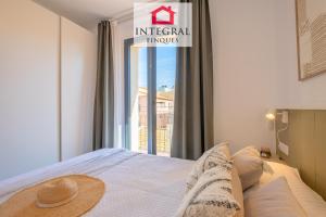 a bedroom with a bed and a window with a sign at Les Voltes in Palamós