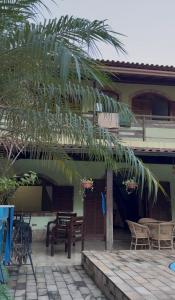 a palm tree in front of a house at Casa com área de lazer em Xerém in Duque de Caxias