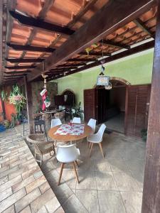a patio with a table and chairs on a patio at Casa com área de lazer em Xerém in Duque de Caxias