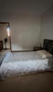 a bedroom with a large bed in a room at Casa com área de lazer em Xerém in Duque de Caxias +8 photos