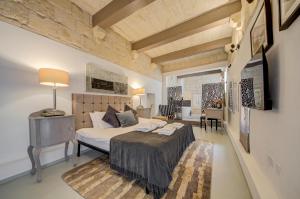 a bedroom with a bed and a table in a room at Zaffir Retreat in Żebbuġ +113 photos