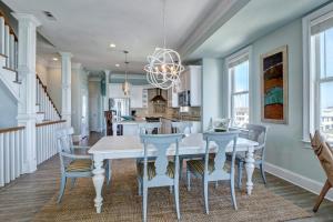 a dining room with a white table and chairs at Tipsy Turtle North- Oceanfront Oasis - Pool - Dog Friendly in Surf City +49 photos