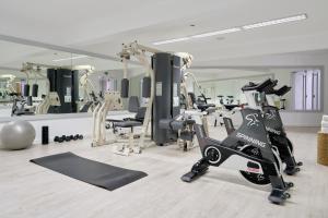 a gym with treadmills and exercise bikes in it at Caloura Hotel Resort in Caloura