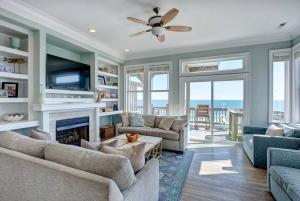a living room with a fireplace and a tv at Tipsy Turtle South-bOceanfront Oasis - Dog Friendly - Pool in Surf City