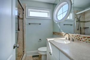 a bathroom with a sink and a mirror and a toilet at Tipsy Turtle South-bOceanfront Oasis - Dog Friendly - Pool in Surf City