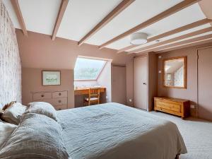 a bedroom with a large bed and a desk at Coelard The Barn - Uk50538 in Appin