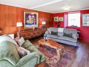 a living room with two couches and a coffee table at Coelard The Barn - Uk50538 in Appin