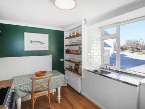 a kitchen with a table and a sink and a window at Coelard The Barn - Uk50538 in Appin