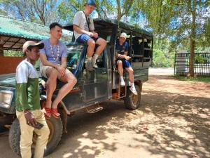 a group of people sitting on the back of a truck at Yala Thaman Katharagama in Kataragama