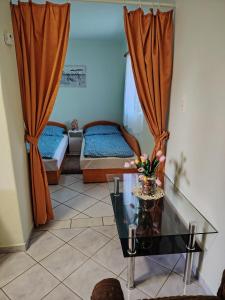 a living room with two beds and a glass table at Horváth kuckó in Fonyód