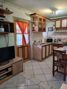 a kitchen with wooden cabinets and a table and a window at Horváth kuckó in Fonyód +9 photos