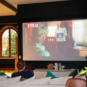 a man sitting on a couch in front of a large screen at The Chapel - Telford in Telford +22 photos
