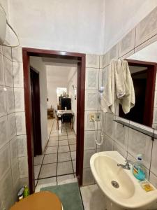 a bathroom with a sink and a toilet and a mirror at Confort total, cerca de todo in Asunción