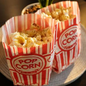 two bags of popcorn on a plate with a plate of food at The Chapel - Telford in Telford