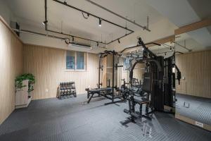 a gym with several treadmills and machines in a room at Daegu Hyeonpung Prana Hotel in Daegu