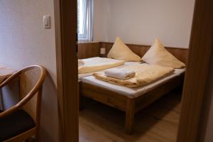 a bedroom with two beds with pillows on them at Penzion nad Halou in Lázně Kynžvart