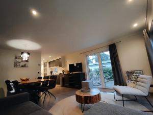 a living room with a table and a dining room at Forest Family 6 persoons op 5 sterren park in Beekbergen