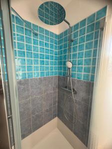 a bathroom with a shower with blue tiles at Villa Horizon in Nice