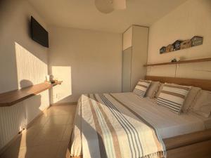 a bedroom with a bed and a tv on the wall at Villa Horizon in Nice