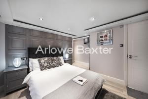 a bedroom with a bed and a sign that reads approve beater at Hackney Suites - En-suite rooms & amenities in London