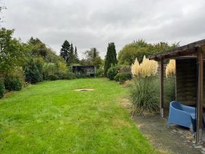 a yard with a blue bench in the grass at Work & Stay - Monteurzimmer - FeWo am NOK in Rendsburg