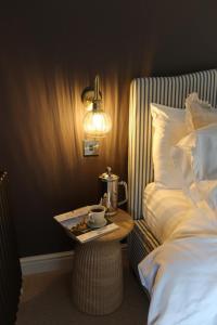 a bed room with a tray with a coffee pot on a table at Plum Cottage in Cottesmore