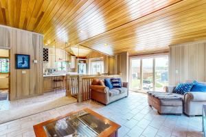 a living room with a couch and a table at The Boat House w/ Dock: Enjoy Lake Life! in North Webster