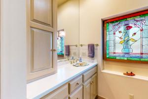 a bathroom with a sink and a stained glass window at The Boat House w/ Dock: Enjoy Lake Life! in North Webster +16 photos