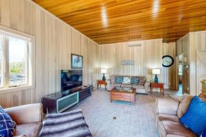 a living room with a couch and a tv at The Boat House w/ Dock: Enjoy Lake Life! in North Webster