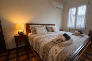 a bedroom with a bed with towels on it at Villa Magnolia in Vicenza